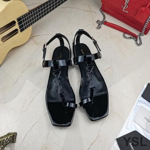 Yves Saint Laurent Cassandra Sandalias Planas con punto de Apoyo Bucle En charol Negro